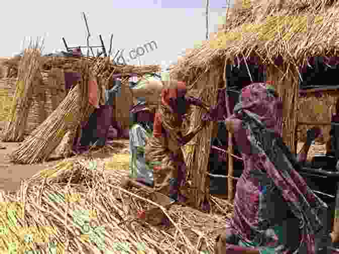 A Group Of Impoverished Chadians Standing Near A Dilapidated House. Life In The Time Of Oil: A Pipeline And Poverty In Chad